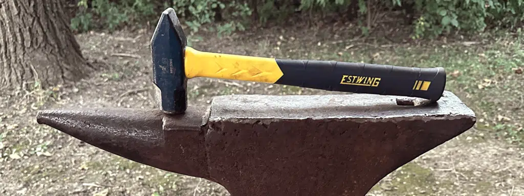 Estwing Sure Strike 32-oz. Blacksmith Hammer resting on anvil.